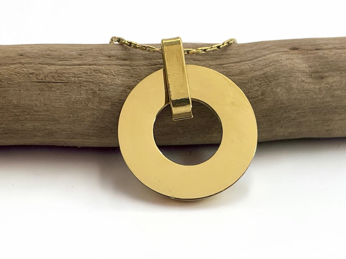 Collier médaille ronde ajourée en acier doré, face lisse prête à graver, sur une branche
